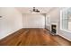 Cozy living room features hardwood floors, fireplace, and large windows for natural light at 3707 Mcguire Nw St, Kennesaw, GA 30144