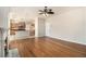 Open living space showcasing wood floors, fireplace, and a view into the modern kitchen at 3707 Mcguire Nw St, Kennesaw, GA 30144