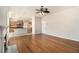 Bright, open-concept living space featuring hardwood floors, a fireplace, and kitchen views at 3707 Mcguire Nw St, Kennesaw, GA 30144