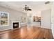 Open-concept living room featuring a cozy fireplace and gleaming hardwood floors at 3707 Mcguire Nw St, Kennesaw, GA 30144