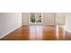 Bright, open space with hardwood floors, baseboard trim, and a large window offering a view of the outdoors at 3707 Mcguire Nw St, Kennesaw, GA 30144