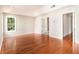 Bright main bedroom with hardwood floors showcases an ensuite bathroom and closet at 3707 Mcguire Nw St, Kennesaw, GA 30144