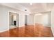 Sunlit main bedroom boasting a tray ceiling, hardwood floors and ensuite bathroom at 3707 Mcguire Nw St, Kennesaw, GA 30144