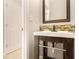 Stylish powder room featuring a modern vanity with a unique mirror and decorative backsplash at 3707 Mcguire Nw St, Kennesaw, GA 30144
