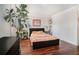 Cozy bedroom featuring hardwood floors, large plant, and neutral tones at 377 Ralph Mcgill Ne Blvd # H, Atlanta, GA 30312