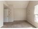 A bedroom with carpet flooring, light gray walls and a large window at 4097 Rosebud Park Dr, Snellville, GA 30039