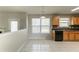 Dining area adjacent to the kitchen features tile floors and large windows at 4097 Rosebud Park Dr, Snellville, GA 30039