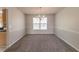 Inviting dining room featuring neutral walls, carpet, and a chandelier creating a warm atmosphere at 4097 Rosebud Park Dr, Snellville, GA 30039