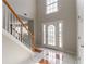 Grand foyer with soaring ceilings, and stylish tile flooring with staircase visible at 4097 Rosebud Park Dr, Snellville, GA 30039