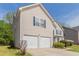 This beautiful home has a two-car garage, a well-kept lawn, and classic suburban charm at 4097 Rosebud Park Dr, Snellville, GA 30039