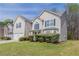 Lovely two-story home with a manicured lawn, complemented by lush greenery and a two-car garage at 4097 Rosebud Park Dr, Snellville, GA 30039