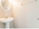 Simple half bathroom featuring a pedestal sink and minimalist design at 4097 Rosebud Park Dr, Snellville, GA 30039