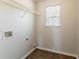 A laundry room with tile flooring, wire shelving, and a window at 4097 Rosebud Park Dr, Snellville, GA 30039