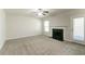 Spacious carpeted living room featuring a fireplace and access to the outdoors at 4097 Rosebud Park Dr, Snellville, GA 30039