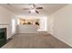 Carpeted living room featuring fireplace, access to the dining area and exterior door at 4097 Rosebud Park Dr, Snellville, GA 30039