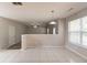 Open-concept living room featuring neutral paint, white tile floors, and a large window at 4097 Rosebud Park Dr, Snellville, GA 30039