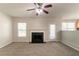 Open living room with a fireplace and access to the dining room and kitchen at 4097 Rosebud Park Dr, Snellville, GA 30039
