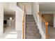 Inviting foyer with a carpeted staircase and wood railing leading to the upper level at 4097 Rosebud Park Dr, Snellville, GA 30039