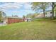 Expansive backyard featuring lush lawn, a brick home with chimney, and a sunroom for outdoor enjoyment at 468 Windol Ct, Marietta, GA 30066
