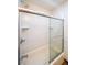 Clean bathroom featuring a shower/tub combination with sliding glass doors and tiled walls at 468 Windol Ct, Marietta, GA 30066