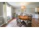 Dining room with hardwood floors, round table, and natural light streaming through the windows at 468 Windol Ct, Marietta, GA 30066