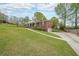 View of the exterior with a long driveway leading to a two-car garage and a well-maintained lawn at 468 Windol Ct, Marietta, GA 30066