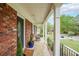 Inviting covered porch with white columns, a rocking chair, and a view of the landscaped front yard at 468 Windol Ct, Marietta, GA 30066