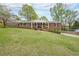 Charming brick home with a large front yard, mature trees, and welcoming front porch with white columns at 468 Windol Ct, Marietta, GA 30066