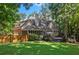 A beautiful lush backyard with a deck, screened in porch, and mature trees create an outdoor oasis at 788 Old Paper Mill Dr, Marietta, GA 30067