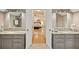 Bathroom with dual vanities and an open doorway leading to the primary bedroom at 788 Old Paper Mill Dr, Marietta, GA 30067