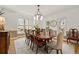 Elegant dining room featuring classic wainscoting, hardwood floors, and large windows at 788 Old Paper Mill Dr, Marietta, GA 30067