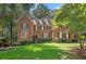 Charming brick home featuring a well-manicured lawn and mature trees at 788 Old Paper Mill Dr, Marietta, GA 30067