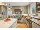 Bright kitchen featuring custom cabinets, a copper sink, a stainless steel range, and hardwood floors at 788 Old Paper Mill Dr, Marietta, GA 30067