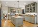 Open concept kitchen with stainless steel appliances, custom cabinets, island, and hardwood floors at 788 Old Paper Mill Dr, Marietta, GA 30067