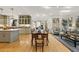 Open concept living and dining room with hardwood floors and custom kitchen in the background at 788 Old Paper Mill Dr, Marietta, GA 30067