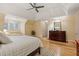 Large main bedroom with hardwood floors and a tray ceiling, features windows and a seating area at 788 Old Paper Mill Dr, Marietta, GA 30067