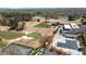 Aerial view of the golf course, tennis court, clubhouse, and pool at Brookfield Country Club at 11630 Mountain Laurel Dr, Roswell, GA 30075