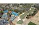 Expansive aerial view showcasing a golf course, tennis courts, and neighborhood amenities in a green setting at 11630 Mountain Laurel Dr, Roswell, GA 30075