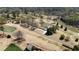 Scenic aerial view of a golf course with tree-lined fairways and a charming house along the course at 11630 Mountain Laurel Dr, Roswell, GA 30075