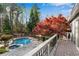 Stunning backyard featuring a swimming pool, spa, mature trees, and a spacious deck at 11630 Mountain Laurel Dr, Roswell, GA 30075