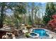 Stunning backyard oasis featuring a pool, spa, stone fireplace, and outdoor kitchen, perfect for entertaining and relaxation at 11630 Mountain Laurel Dr, Roswell, GA 30075