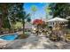 Enjoy a backyard oasis with a pool, stone patio, and outdoor dining area, perfect for entertaining at 11630 Mountain Laurel Dr, Roswell, GA 30075