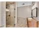 Modern bathroom with a glass-enclosed shower, wooden vanity, and stylish fixtures at 11630 Mountain Laurel Dr, Roswell, GA 30075