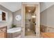 Serene bathroom featuring a glass-enclosed shower and a separate soaking tub with natural light at 11630 Mountain Laurel Dr, Roswell, GA 30075
