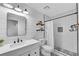 Charming bathroom with shiplap walls, updated vanity, and a subway-tiled shower with decorative floor at 11630 Mountain Laurel Dr, Roswell, GA 30075