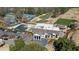 Aerial view of a clubhouse with a pool, golf course, and tennis courts enhancing the community's lifestyle at 11630 Mountain Laurel Dr, Roswell, GA 30075