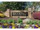 Brookfield Country Club sign surrounded by colorful flowers and greenery at 11630 Mountain Laurel Dr, Roswell, GA 30075
