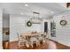 Cozy dining room with shiplap walls, modern light fixture, and access to outdoor deck at 11630 Mountain Laurel Dr, Roswell, GA 30075