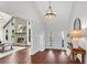 Bright and airy foyer with hardwood floors, decorative accents, and a glimpse into the open-concept living space at 11630 Mountain Laurel Dr, Roswell, GA 30075