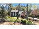 Charming two-story home featuring a stone chimney and a beautifully landscaped front yard at 11630 Mountain Laurel Dr, Roswell, GA 30075